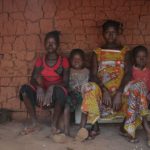 Democratic Republic of the Congo. Refugee family from Central African Republic in front of new transitional shelter